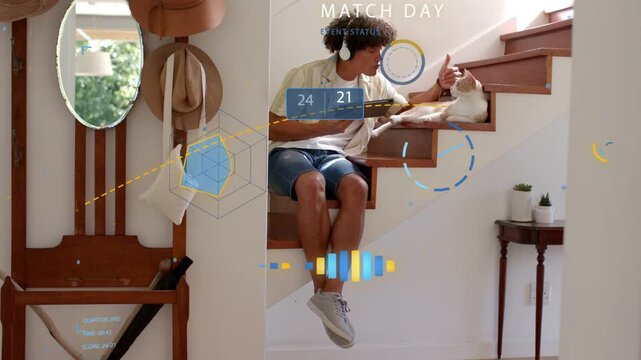 Glancing man wearing headphones checking tablet with MATCH DAY HUD appearing at foyer, stroking cat