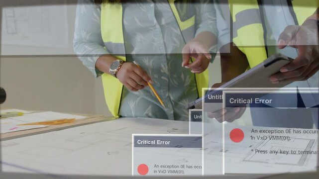 Gesturing team in vests reviewing plans with pencil at site office tablet showing error dialogs