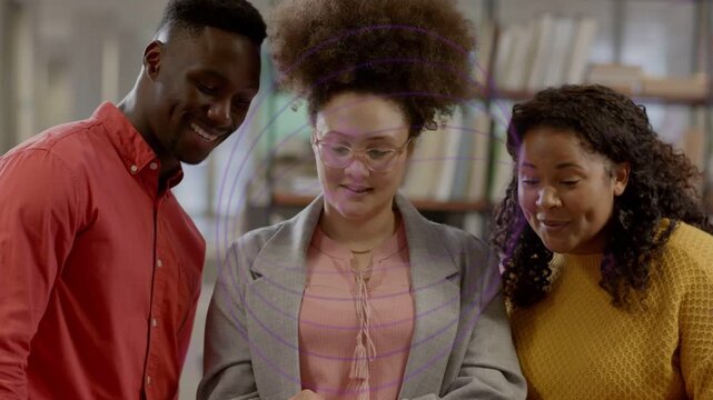 Team of three leaning in central woman tapping screen animated charts growing over tablet for study