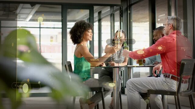 After man offering bottle, team of four clinking glasses at round table, wearing casual attire