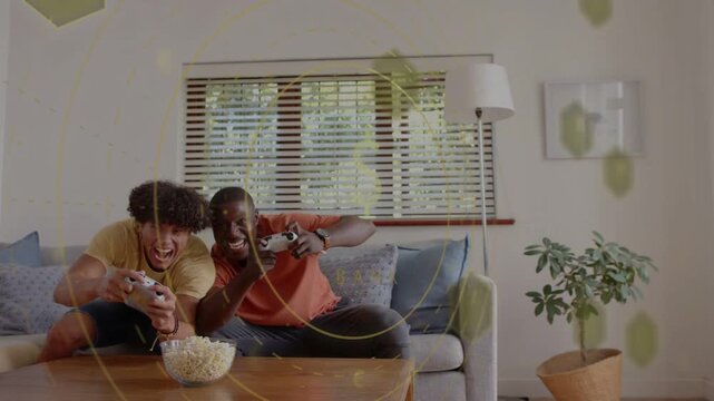 Reacting to game start men in colorful tees on living-room couch with wired controllers and popcorn