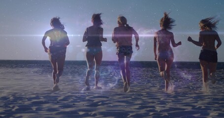 Obraz premium Running five women moving toward ocean at sunset on wet sand, wearing swimsuits and splashing