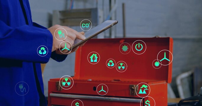 Holding tablet, tech blue-jacketed tapping screen in workshop, red tool chest, AR icons, copy space