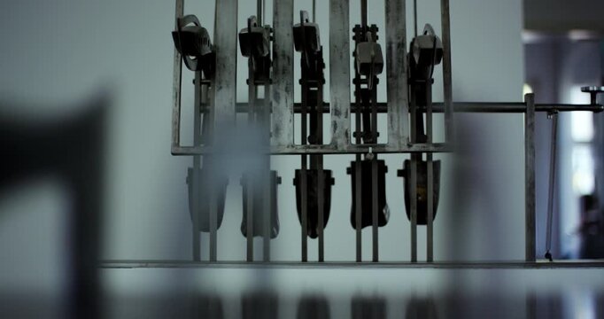 Close up of industrial metal machinery parts with mechanical levers in a factory setting