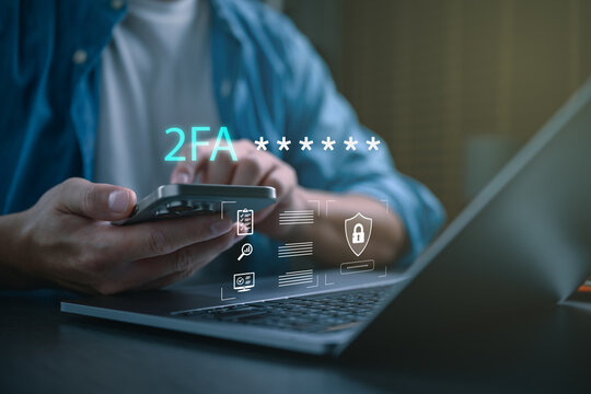 User verifying identity with two factor authentication on smartphone, entering secure code with laptop, representing account protection, digital security, login verification, safe access.