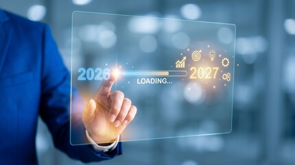 Fototapeta premium Businessman's finger touches futuristic screen loading bar from 2026 to 2027 with glowing touching
