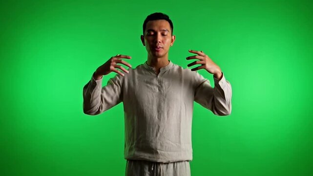 Young man performing tai chi movements.