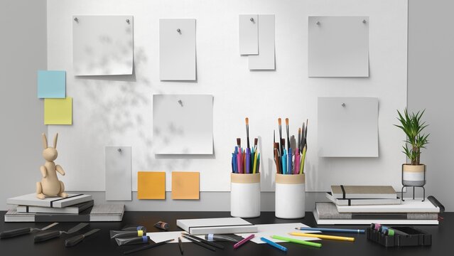 Creative artist workspace mockup with blank posters, brushes and stationery desk scene