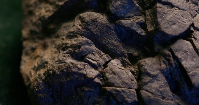 Close-up rocky surface with blue light and rugged texture