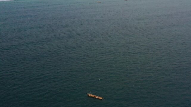 Cinematic drone footage of ocean with local fishing boats in Ada, Ghana. Captures coastal life, waves, and movement&mdash;ideal for documentaries, travel, and commercial use.