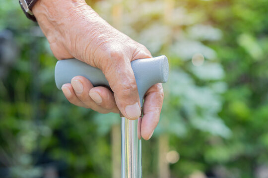 Alzheimers, cane and closeup of elderly person's hand with disability in retirement for medical assisted living