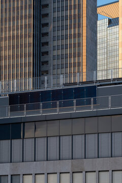 Urban architecture detail of modern building facade where grid windows reveal texture layers and subtle pattern across a quiet city exterior