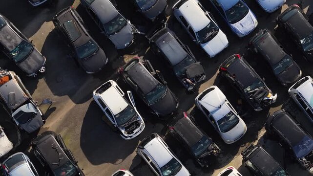 Drone shot of cars graveyard. Automotive industry. Fossil fuels emissions.