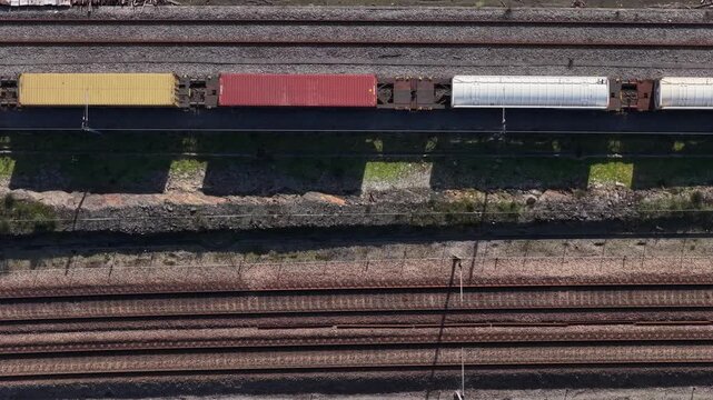 Aerial view of train cargo wagons with shipping containers.