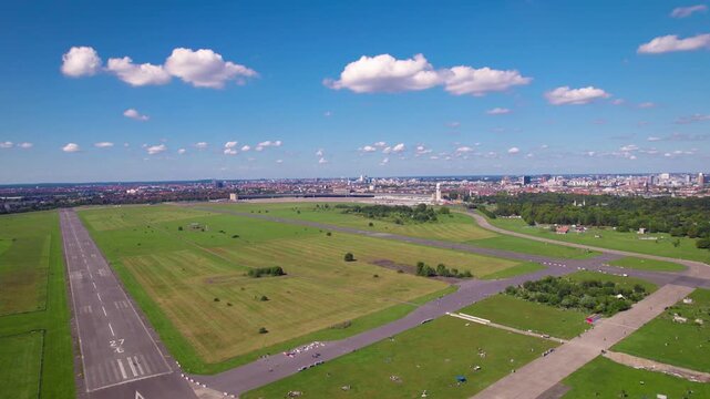 xpansive aerial view of the historic tempelhof airport, now a public park, with berlin skyline