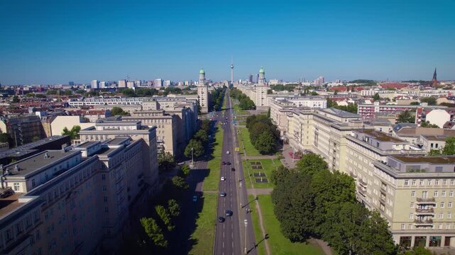 Aerial footage of karl-marx alee, a wide, straight road cutting through a densely populated urban area in berlin
