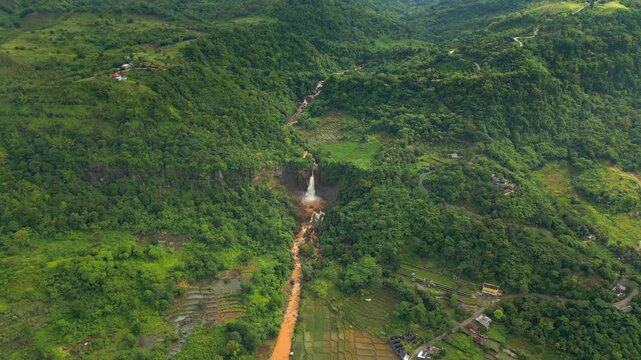 Cimarinjung Waterfall And River Flowing To The Ocean After Heavy Rain Indonesia Drone High Angle 4K 60FPS