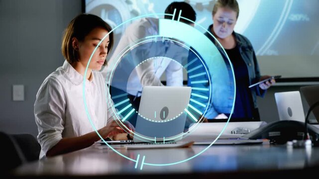 Seated woman typing at laptop, HUD pulsing while team leaning, pointing, tapping tablets for review