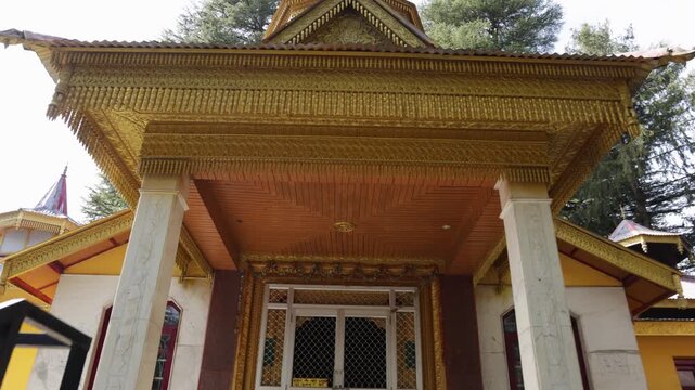 ornate hindu temple entrance with golden roof and carved details in forest setting shot is taken at Jai Maa Tara Devi Temple shimla,
