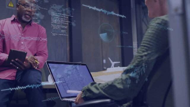 Gesturing man in pink shirt mentoring woman in green top over laptop floorplan amid glass overlays