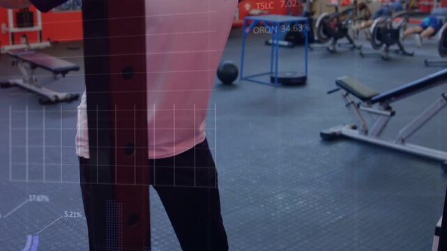 Male lifter adjusting grip, initiating squat descent in gym while analytics charts tracking form
