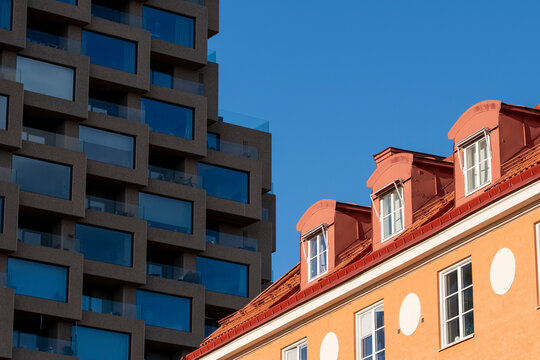 Contrast of rooftops and skyscraper in Stockholm Hagastaden where modern urban architecture and facade lines meet bright sky in a changing cityscape