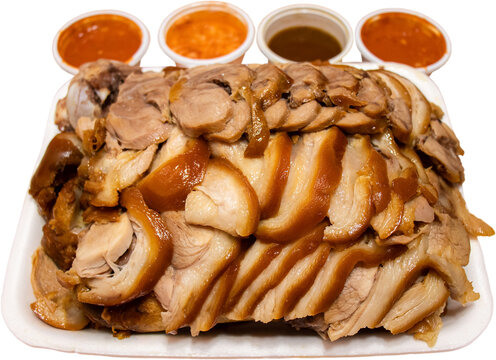 Korean Jokbal (braised pig&rsquo;s trotters) with assorted sauces in white foam container isolated on transparent background, PNG