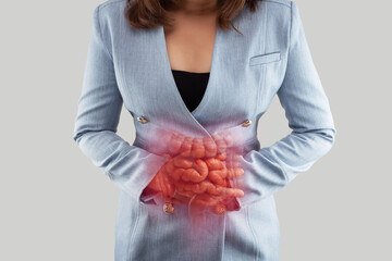 Woman holding abdomen with highlighted intestines showing digestive problems, inflammation, or...