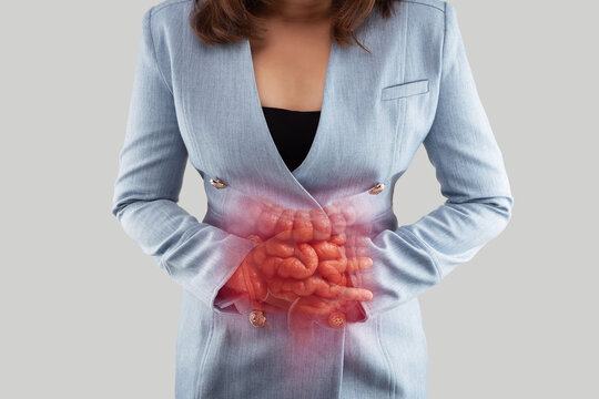Woman holding abdomen with highlighted intestines showing digestive problems, inflammation, or gastrointestinal pain in a medical concept.