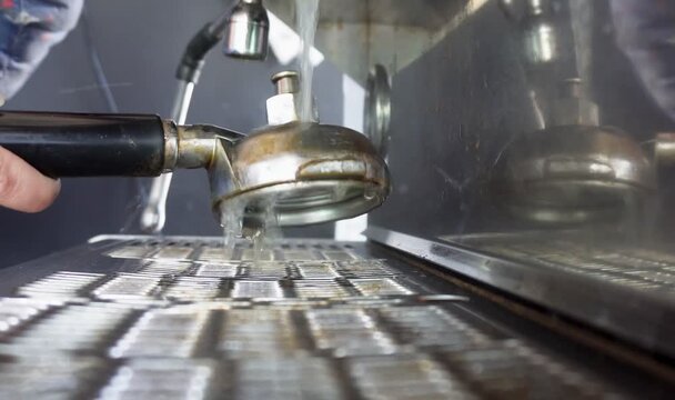 Professional espresso machine group head cleaning with hot water and portafilter