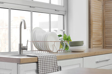 Sink and clean dishes on counter in kitchen