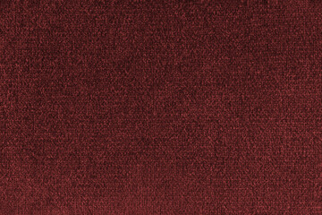 Fototapeta premium Close up, macro of red fabric texture with soft velvet, fluffy woven surface, rich textile detail. Knitted jersey cloth background, backdrop, wallpaper for design, fashion or interior projects