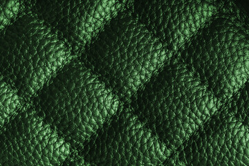 Fototapeta premium Close up, macro of green quilted leather texture with stitched diamond pattern, luxury material surface shining metal effect for fashion, upholstery or design wallpaper, rough, relief background