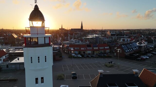 Sun piercing behind lighthouse in near static dawn frame