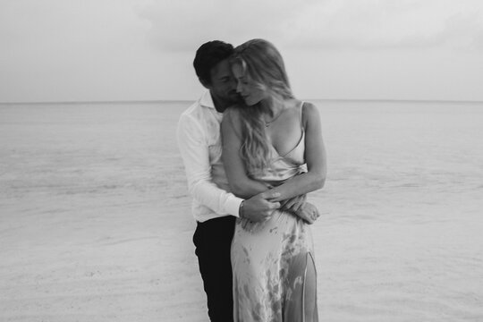 Island serenity: Young couple embracing in love on their wedding day