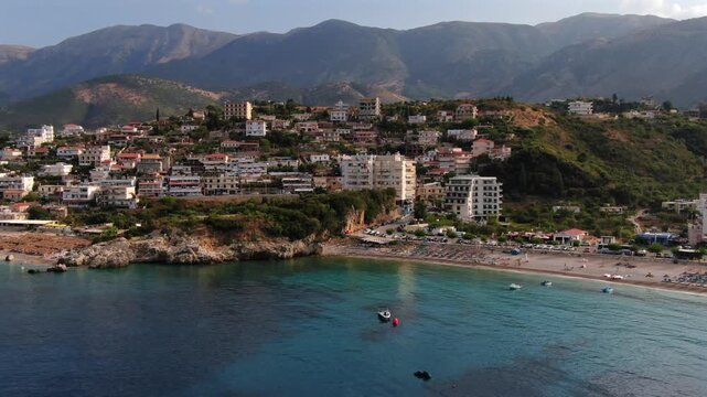 Picturesque seaside town of Himare on the Albanian Riviera. A stunning aerial perspective of the beautiful coastline with azure water and mountains