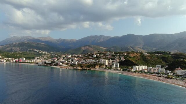Picturesque drone view of the Himare coast in Albania. A sunny summer day showcasing the beautiful sea, beach, and mountains of the Riviera