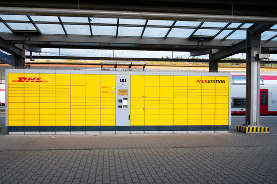 DHL post parcel boxes terminal at railway station in Trier, Germany, storing or deposit parcels for receiver, postal self service 