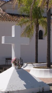 Whitewashed white cross on the door of an Andalusian hermitage. 4K Vertical