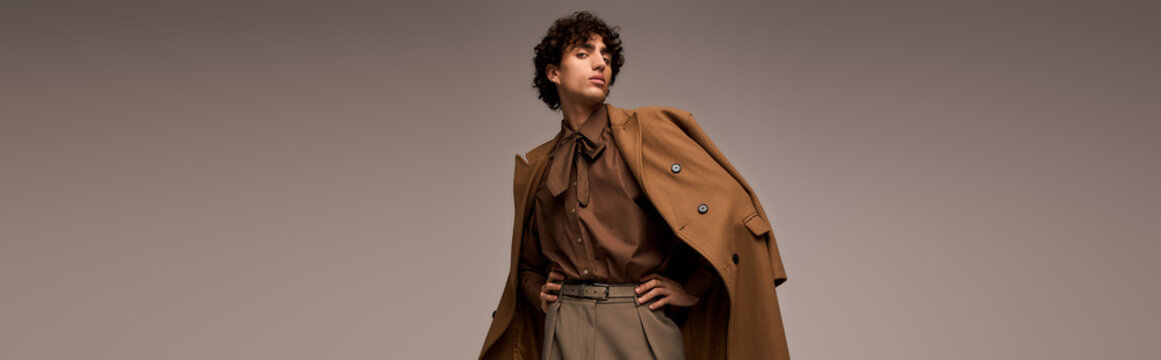 Handsome stylish man showcases modern fashion in a sleek studio setting
