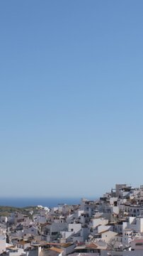 View of a hillside town by the coast under a clear blue sky, Torrox, Spain