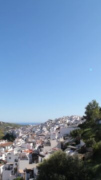 View of a hillside town under a clear blue sky during the day, Torrox, Spain