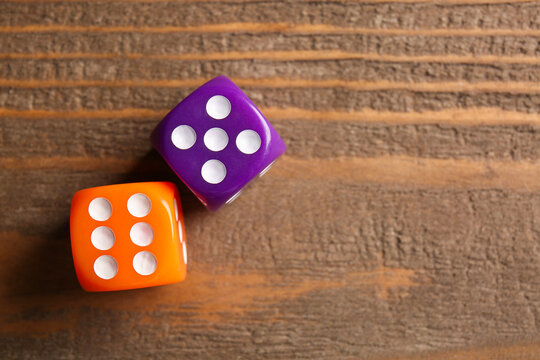 Different dices on wooden background