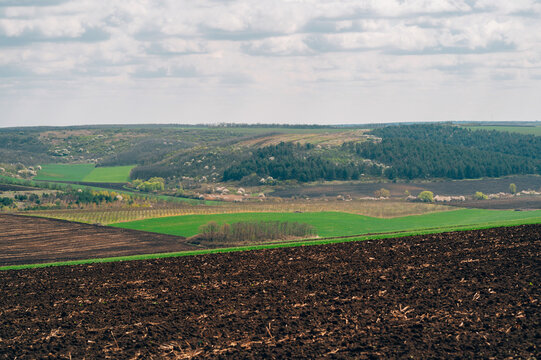 Expansive Valley Farmland Under Soft Clouds, Cultivated Slopes And Patchwork Crops Creating Layered