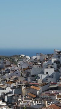 View of a hillside town together the sea, Torrox, Spain. 4K Vertical