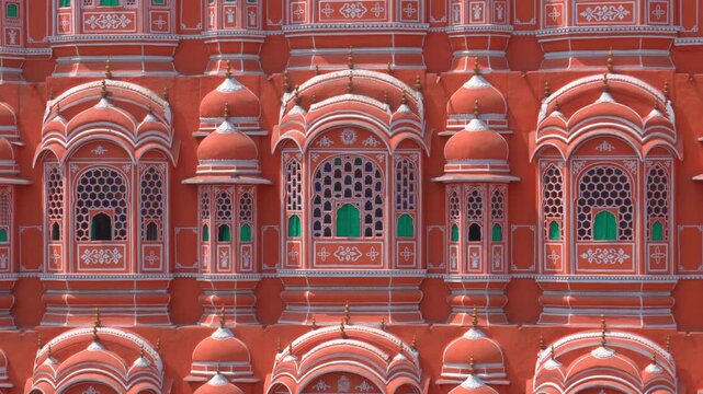 A detailed static close-up shot of the Hawa Mahal (Palace of Winds), showcasing its unique pink sandstone windows, intricate honeycomb design, and white lime patterns.