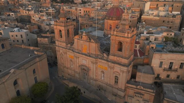 Aerial Drone over Birgu Parish Church of St Lawrence, Three Cities at, Malta Historic Cityscape revealing Sea Skyline of Valletta, Malta