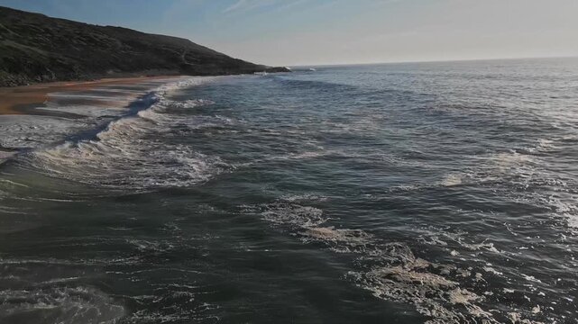 Scenic beach waves at Praia do Salgado in tranquil Nazare, Portugal view