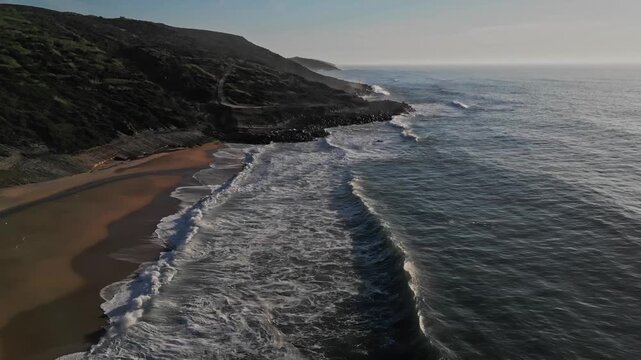 Calm waves at Praia do Salgado, serene evening in Nazar&eacute;, Portugal