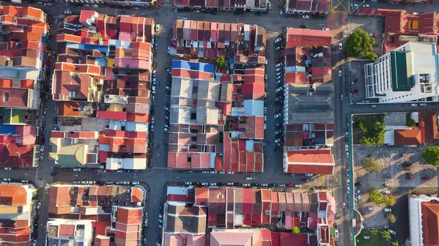 Top-down aerial view of Georgetown's old town in Penang Island, Malaysia. Dense urban grid with colorful rooftops, streets, and historic layout forming a vibrant city pattern. UHD.